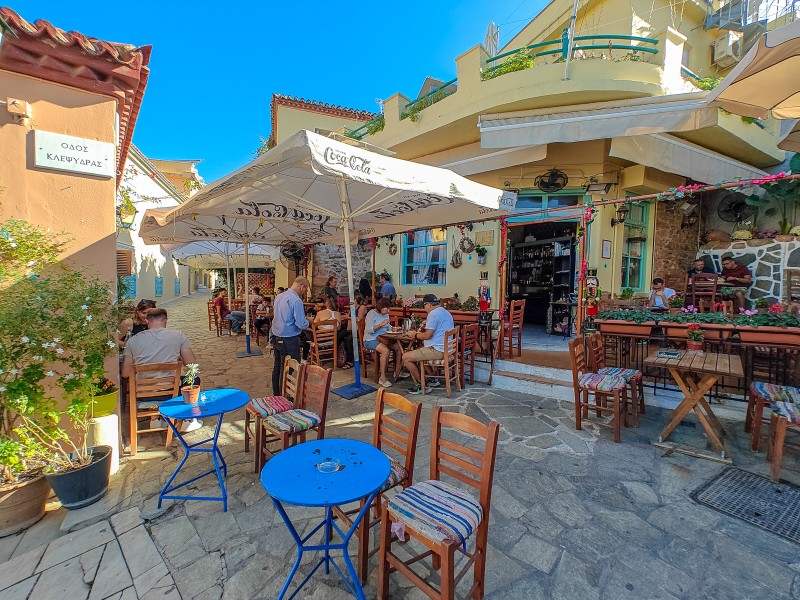 Outdoor cafés and tavernas in the narrow, sunlit streets of Plaka and Anafiotika in Athens