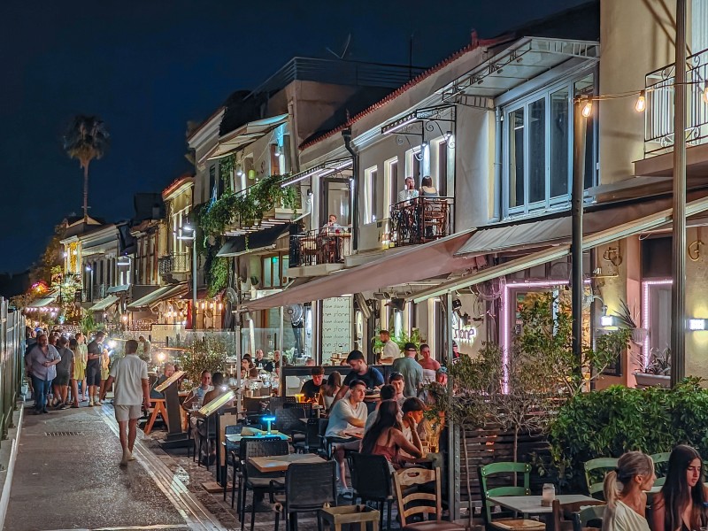 Eat & Drink in Monastiraki - Night view of Adrianou Street in Monastiraki with lively restaurants, lights, and people dining outdoors