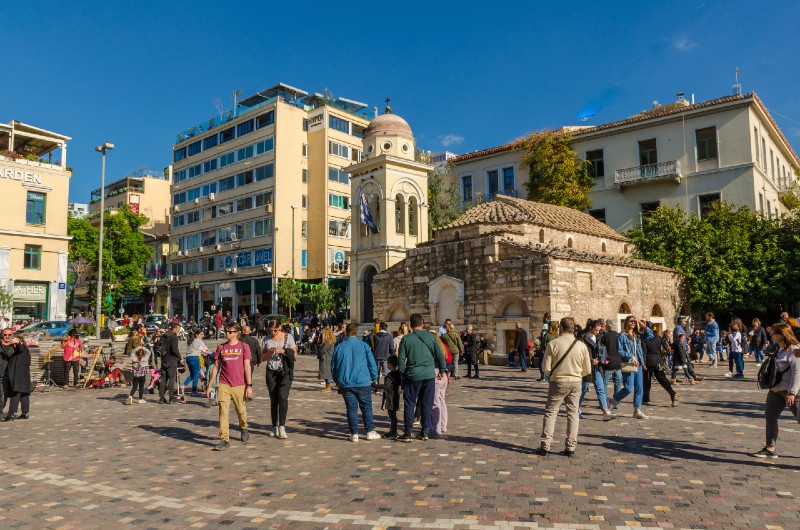 Pantanassa Church at Monastiraki Square surrounded by people and city life under a clear sky