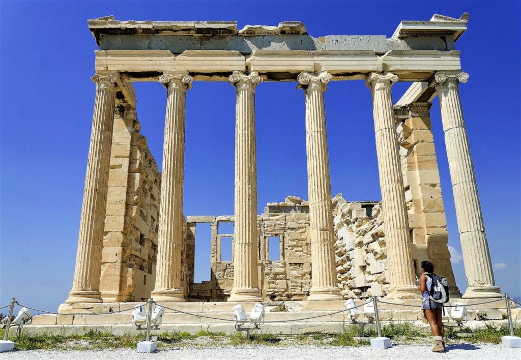 a woman looking the parthenon