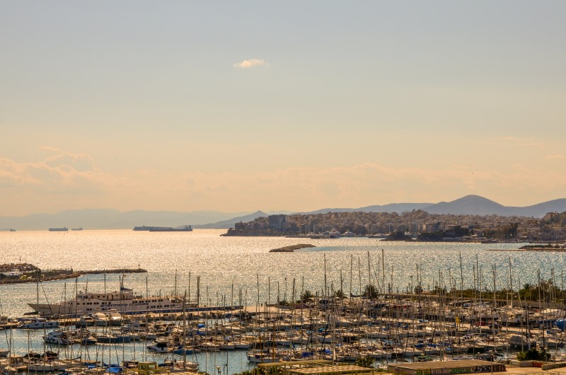 Scenic view of Flisvos Marina in Palaio Faliro with yachts, the sea, and mountains in the background, part of the Athens Riviera.
