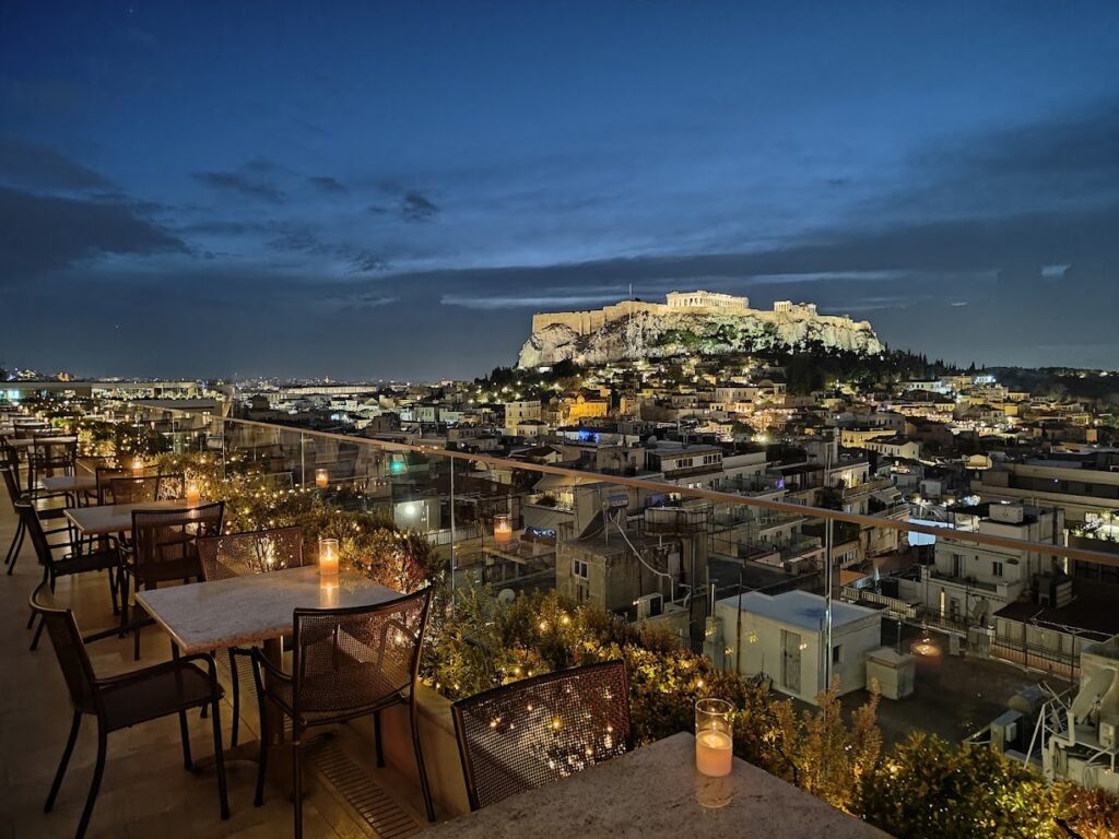 Rooftop bar at Electra Metropolis Hotel in Syntagma, Athens, with stunning night view of the Acropolis — one of the best hotel locations in central Athens.