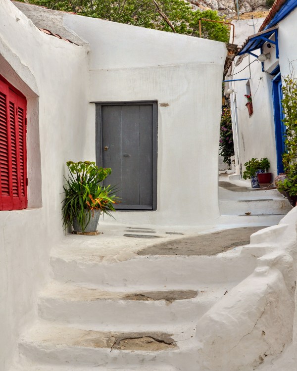 steps and white painted narrow street in Anafiotika