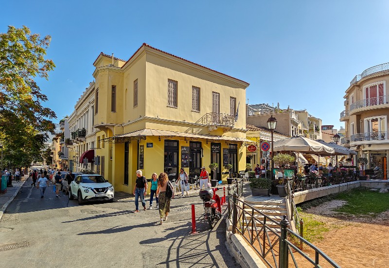 central athens street with cafes and people walking near plaka neighborhood close to the acropolis