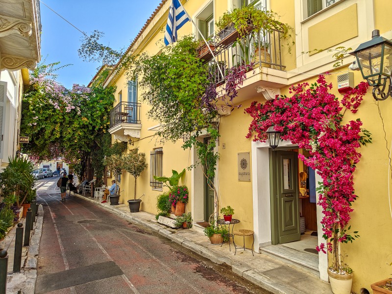 charming plaka street with colorful houses and flowers near the acropolis in athens